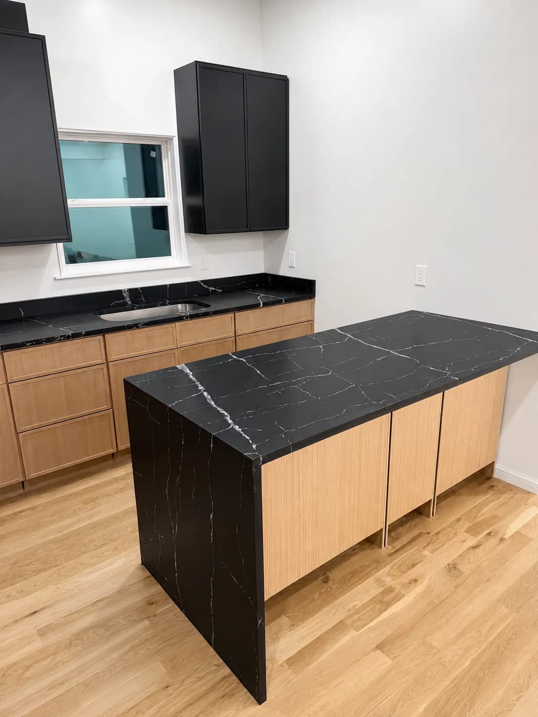 Black quartz waterfall island and matching counters