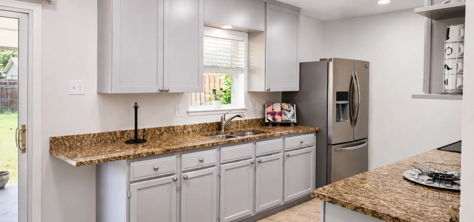Warm-toned natural granite counters in a refreshed kitchen